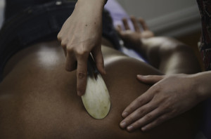 Photo of Margarita administering Gua Sha treatment